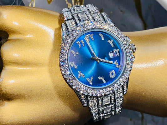 Silver iced-out watch with sapphire blue dial, crystal hour markers, and diamond bracelet – luxury streetwear timepiece

