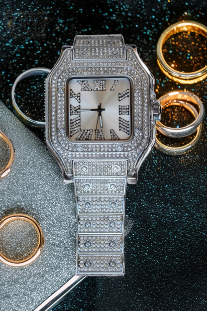 Silver-tone unisex watch with a square dial, crystal-encrusted bezel, and sparkling band. The watch features Roman numeral markers and a luxurious, diamond-studded design, offering a sleek and elegant look.