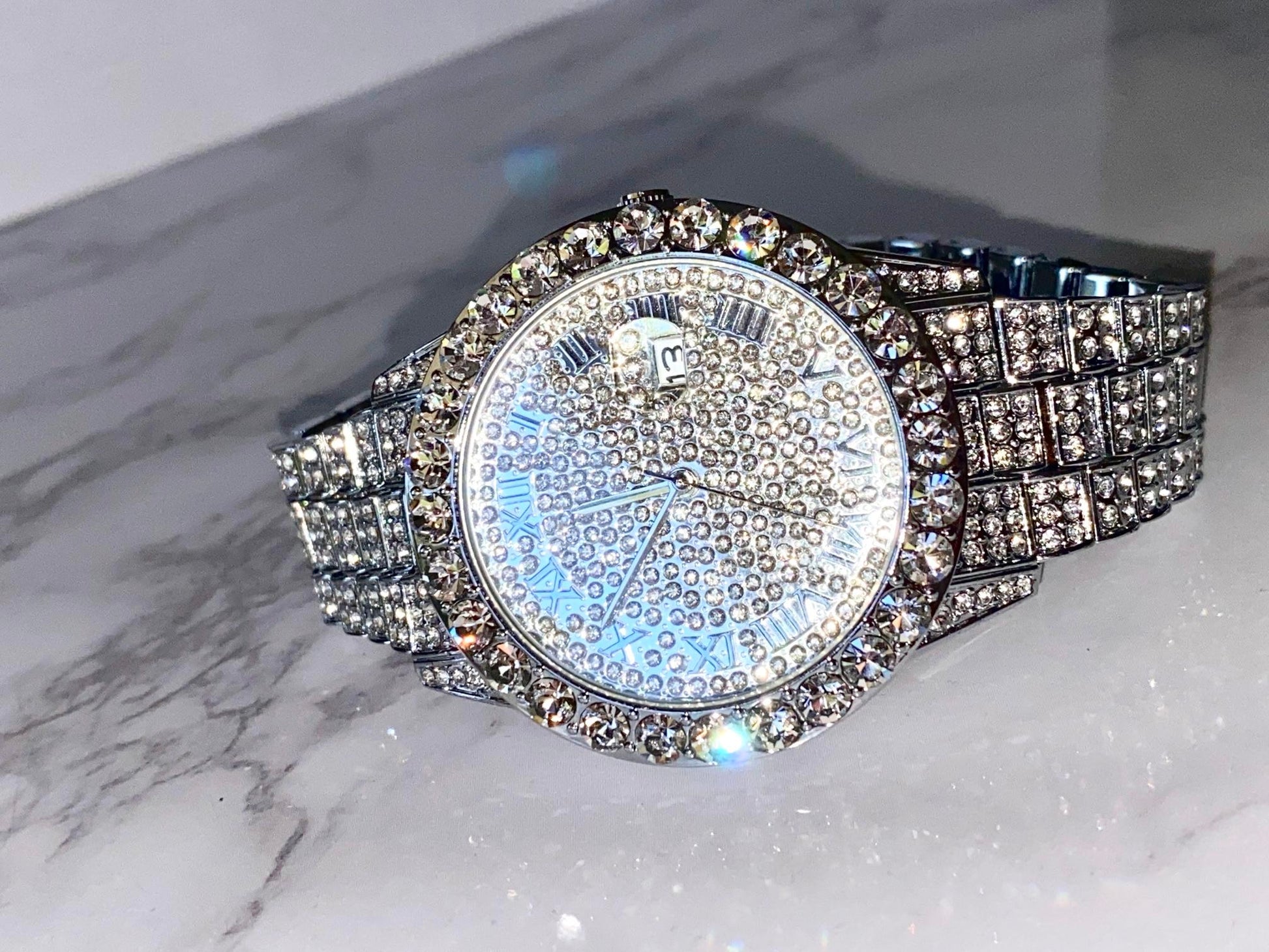 Silver iced-out watch with Roman numeral pavé dial and diamond bracelet – luxury streetwear timepiece