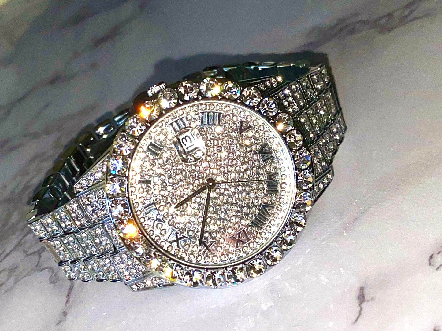 Silver iced-out watch with Roman numeral pavé dial and diamond bracelet – luxury streetwear timepiece