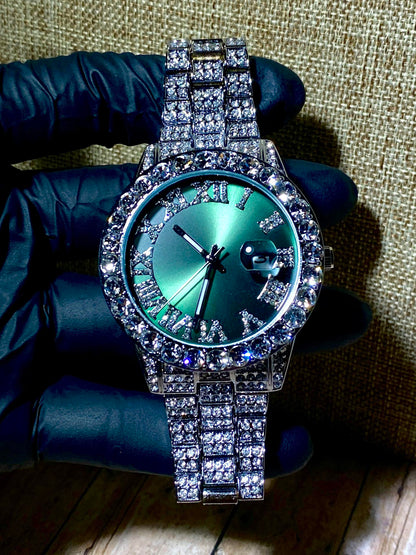 Silver iced-out watch with emerald green dial, Roman numerals, and diamond bracelet – luxury streetwear timepiece