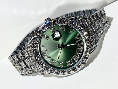 Silver iced-out watch with emerald green dial, Roman numerals, and diamond bracelet – luxury streetwear timepiece