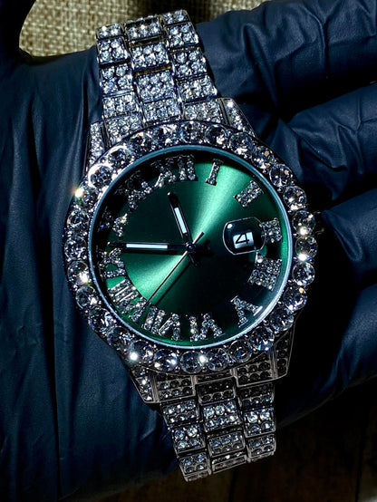 Silver iced-out watch with emerald green dial, Roman numerals, and diamond bracelet – luxury streetwear timepiece