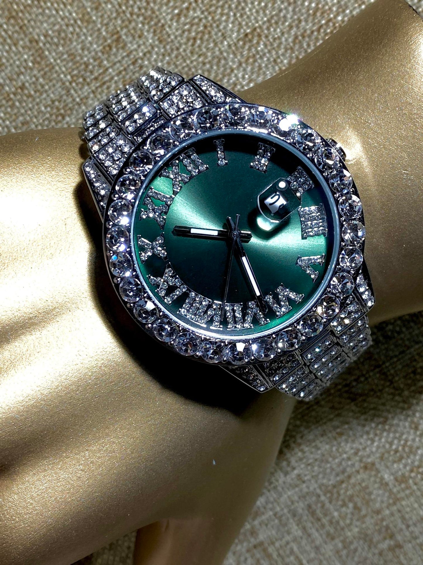 Silver iced-out watch with emerald green dial, Roman numerals, and diamond bracelet – luxury streetwear timepiece