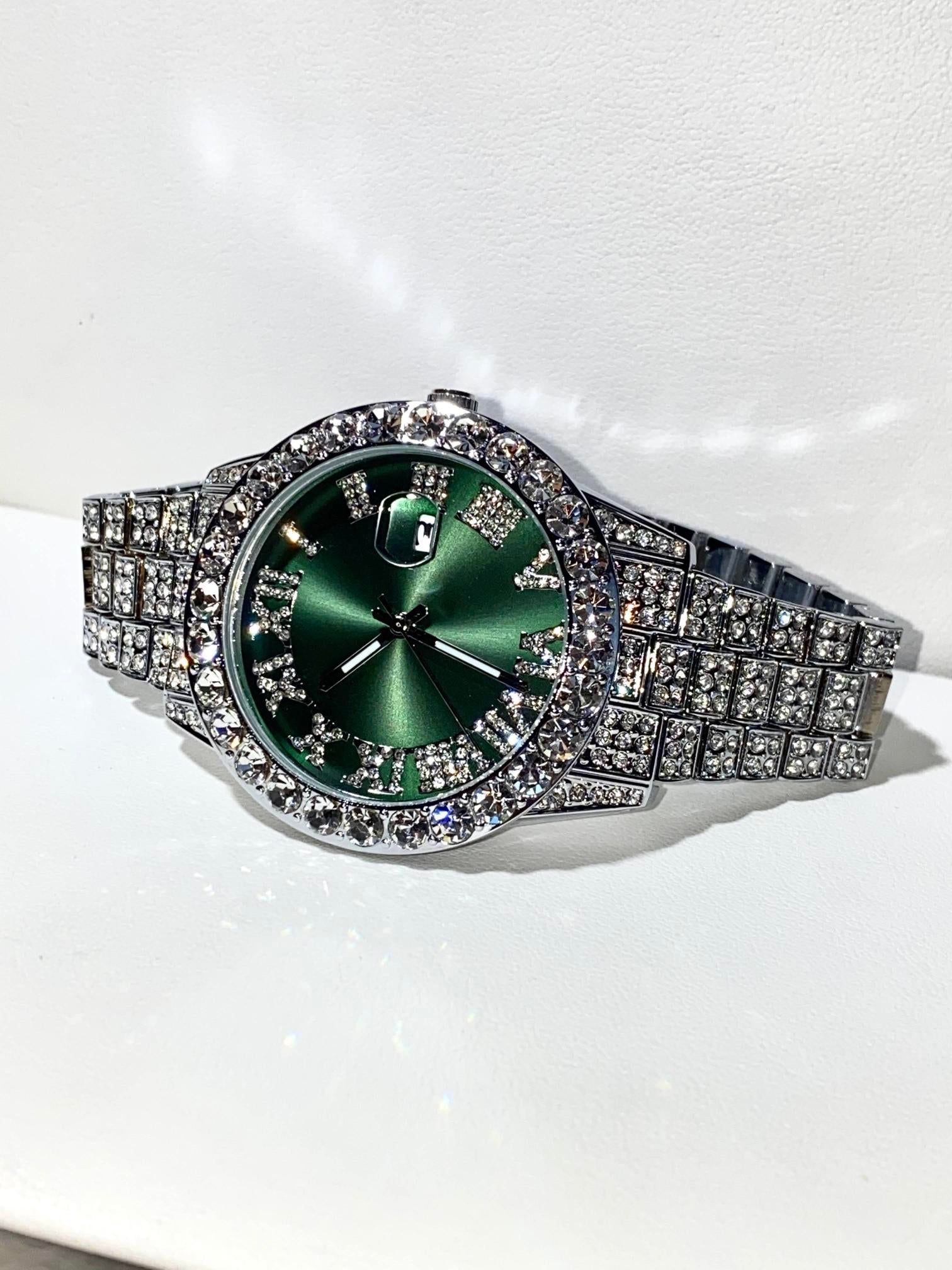 Silver iced-out watch with emerald green dial, Roman numerals, and diamond bracelet – luxury streetwear timepiece