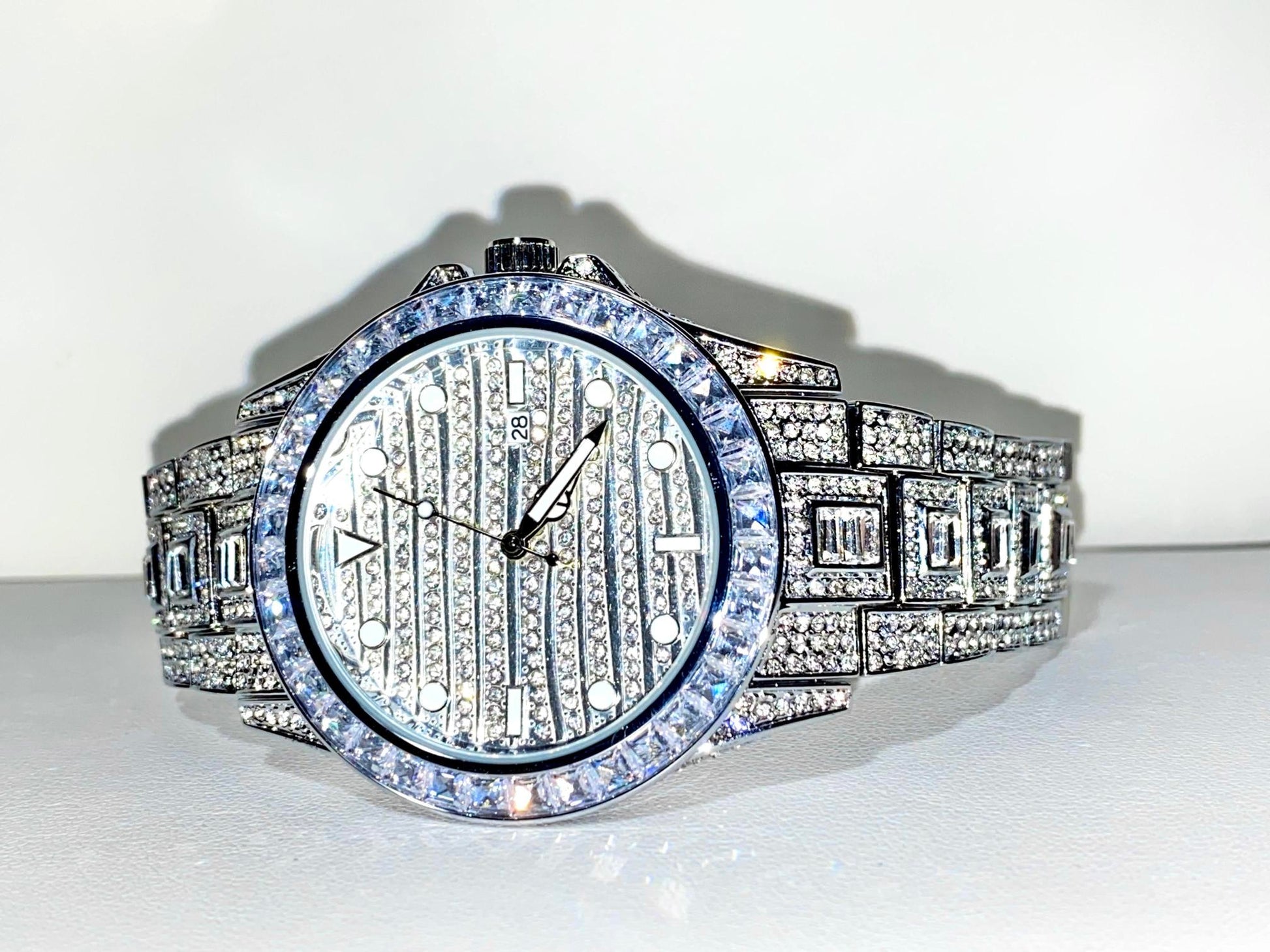 Silver iced-out watch with grid pavé dial, baguette bezel, and diamond bracelet – luxury streetwear timepiece