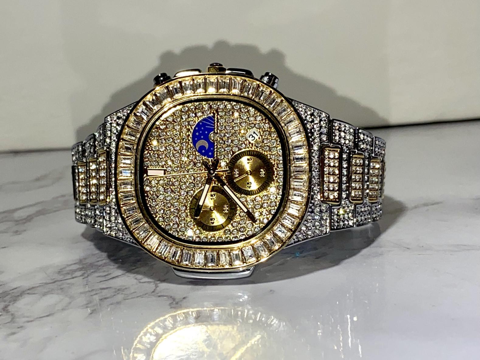 Two-tone iced-out watch with gold dial, moon phase complication, and baguette bezel – luxury diamond timepiece