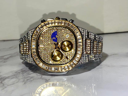Two-tone iced-out watch with gold dial, moon phase complication, and baguette bezel – luxury diamond timepiece