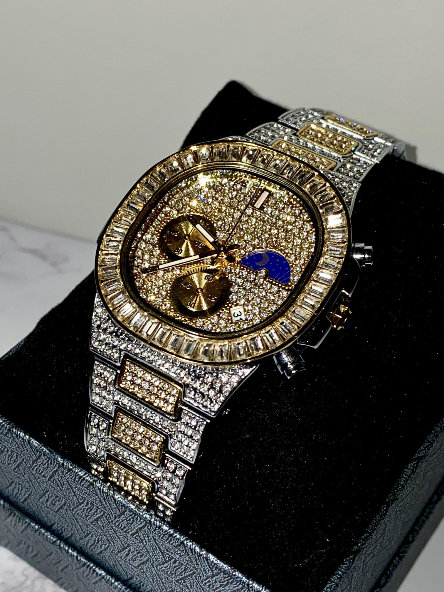 Two-tone iced-out watch with gold dial, moon phase complication, and baguette bezel – luxury diamond timepiece