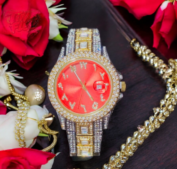 Two-tone silver and gold men's and women's watch with a red dial and diamond-studded bezel. The watch features crystal-encrusted Roman numerals, a date display at the 3 o'clock position, and a luxurious, sparkling band with rectangular stones.