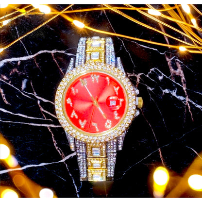 Two-tone silver and gold men's and women's watch with a red dial and diamond-studded bezel. The watch features crystal-encrusted Roman numerals, a date display at the 3 o'clock position, and a luxurious, sparkling band with rectangular stones.