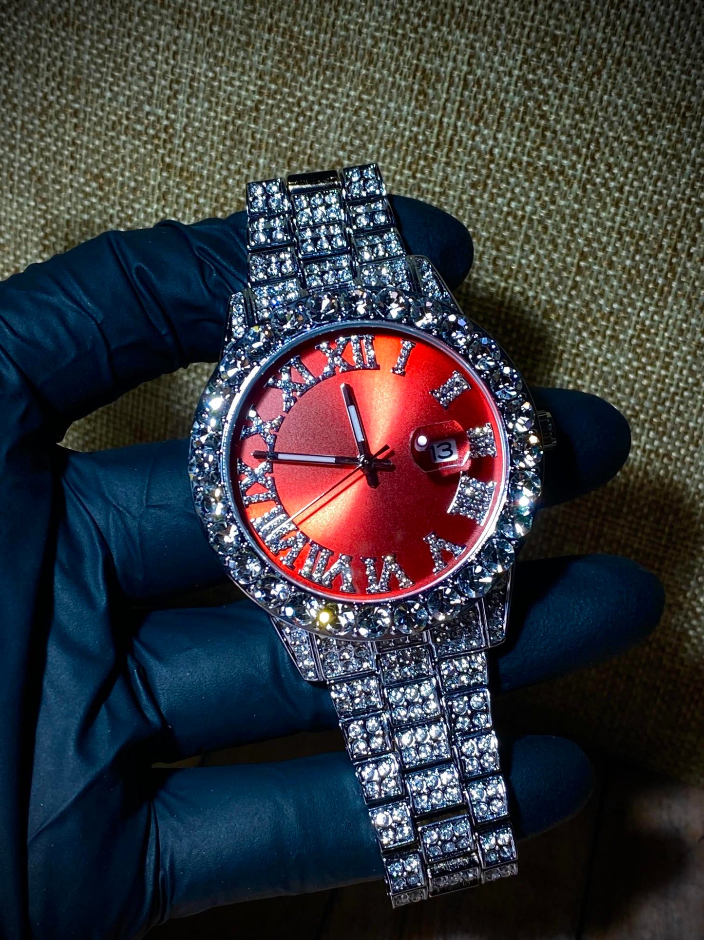 Red dial Roman numeral iced-out watch with crystal bezel and silver pavé band – luxury statement accessory