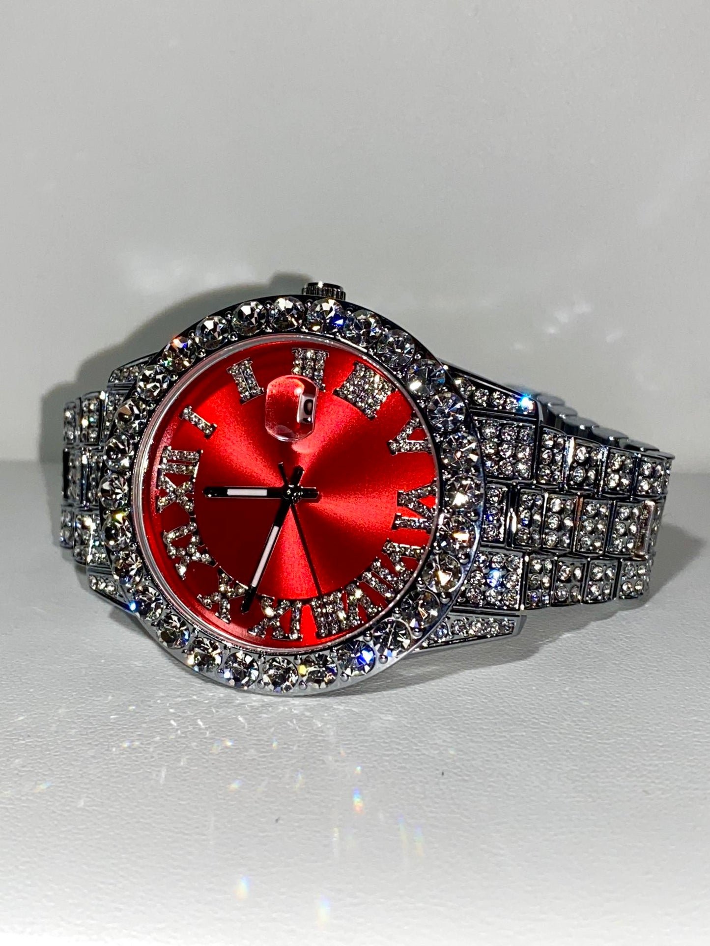 Red dial Roman numeral iced-out watch with crystal bezel and silver pavé band – luxury statement accessory