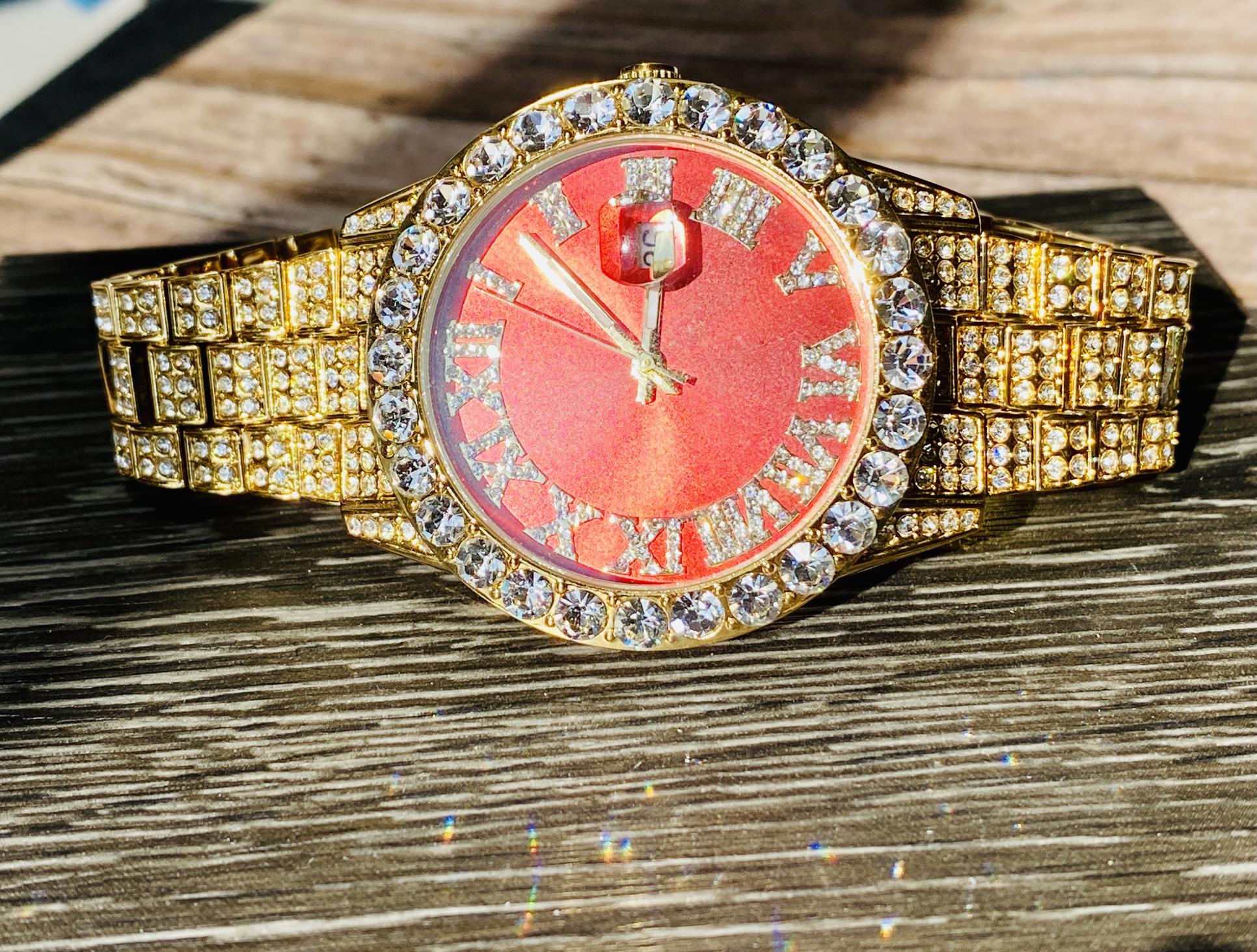 Gold iced-out watch with scarlet red dial, Roman numerals, and diamond bracelet – luxury streetwear timepiece