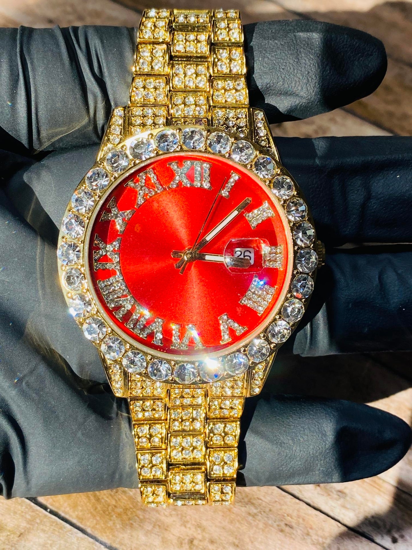Gold iced-out watch with scarlet red dial, Roman numerals, and diamond bracelet – luxury streetwear timepiece