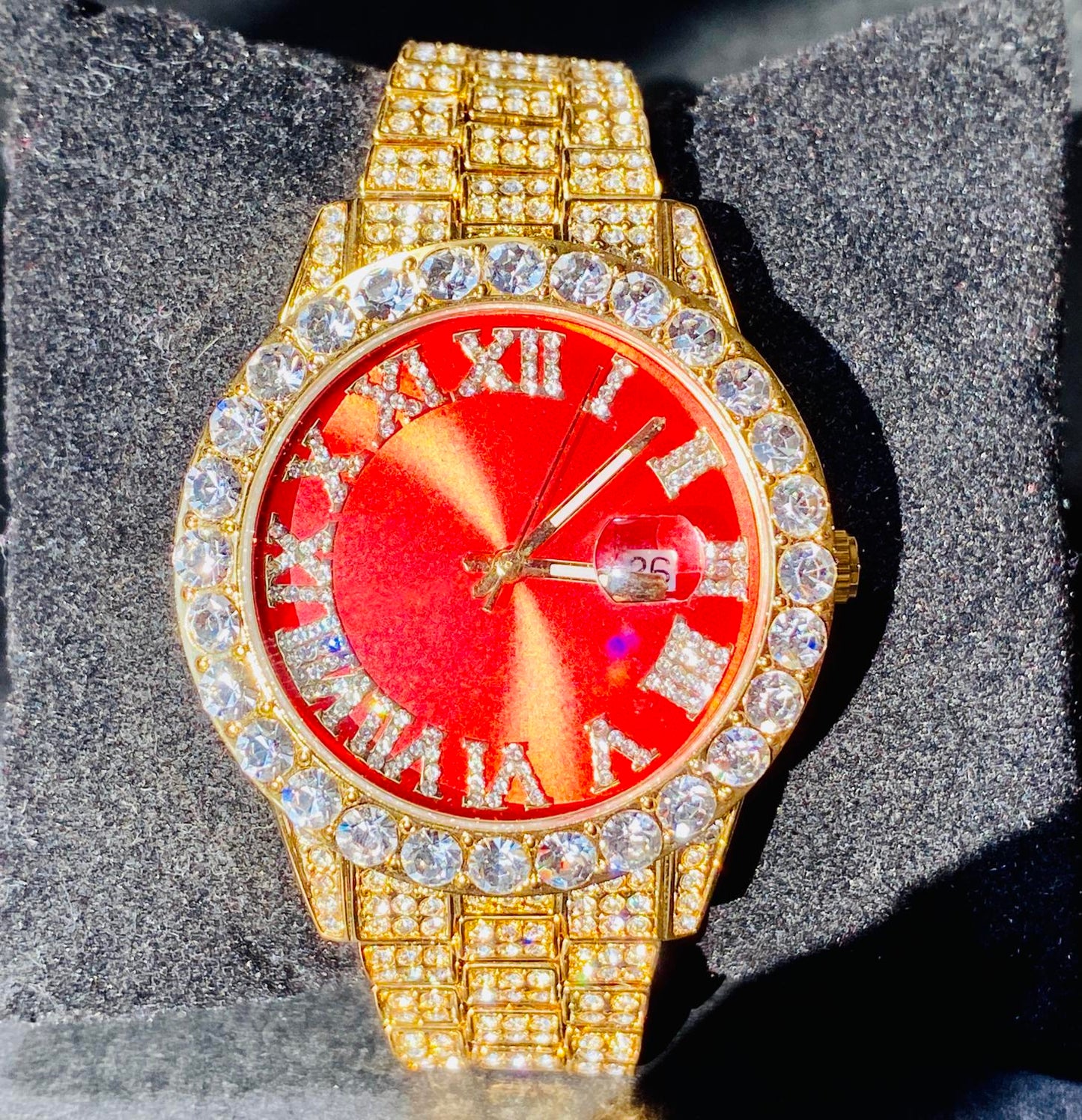 Gold iced-out watch with scarlet red dial, Roman numerals, and diamond bracelet – luxury streetwear timepiece