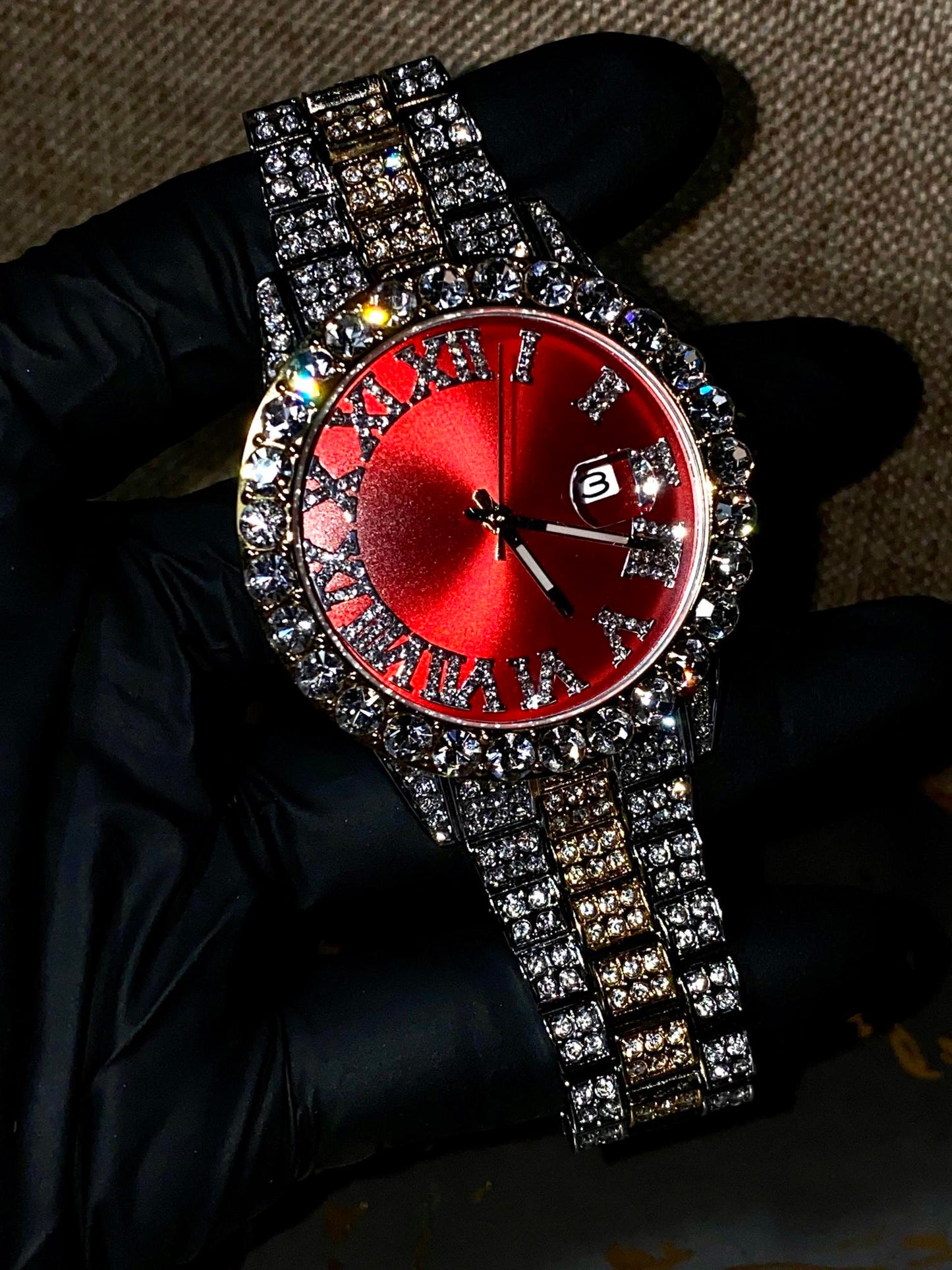 Two-tone iced-out watch with red dial, Roman numerals, and diamond bracelet – luxury streetwear timepiece