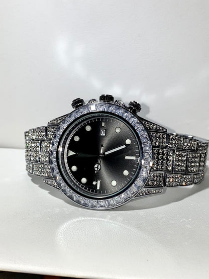 Silver iced chronograph watch with black dial displayed on white ceramic cuff – ShadowFlex 42MM by Time Flex