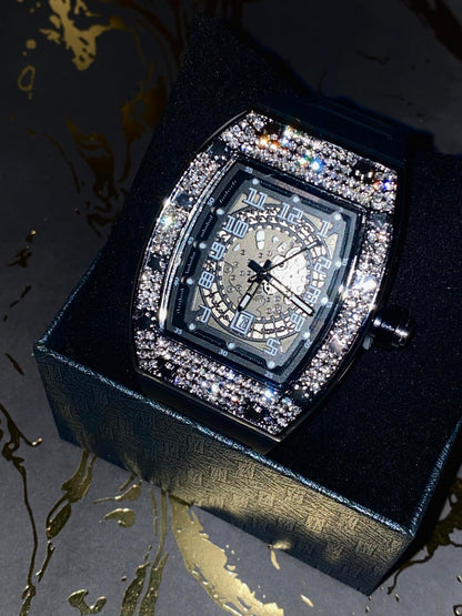 Black iced-out barrel watch with skeleton dial and rubber strap – luxury streetwear style