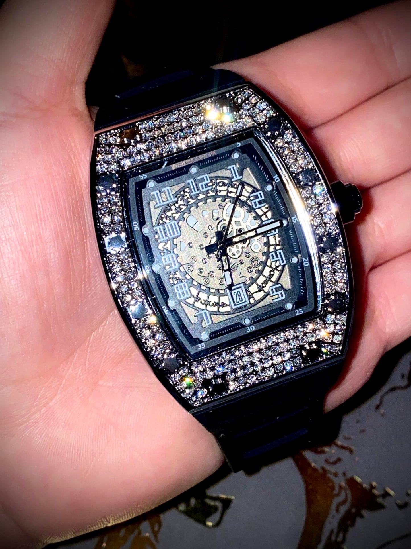 Black iced-out barrel watch with skeleton dial and rubber strap – luxury streetwear style