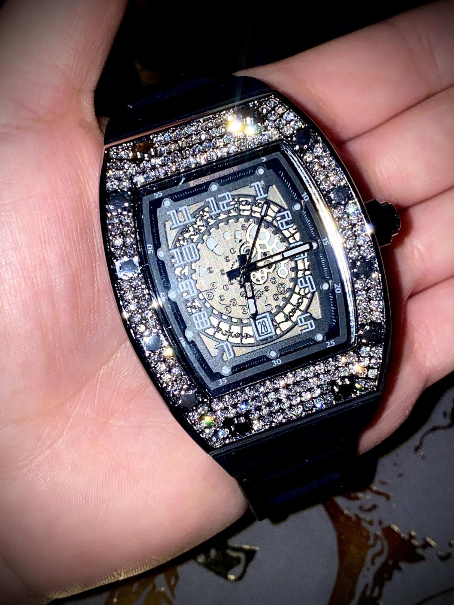 Black iced-out barrel watch with skeleton dial and rubber strap – luxury streetwear style