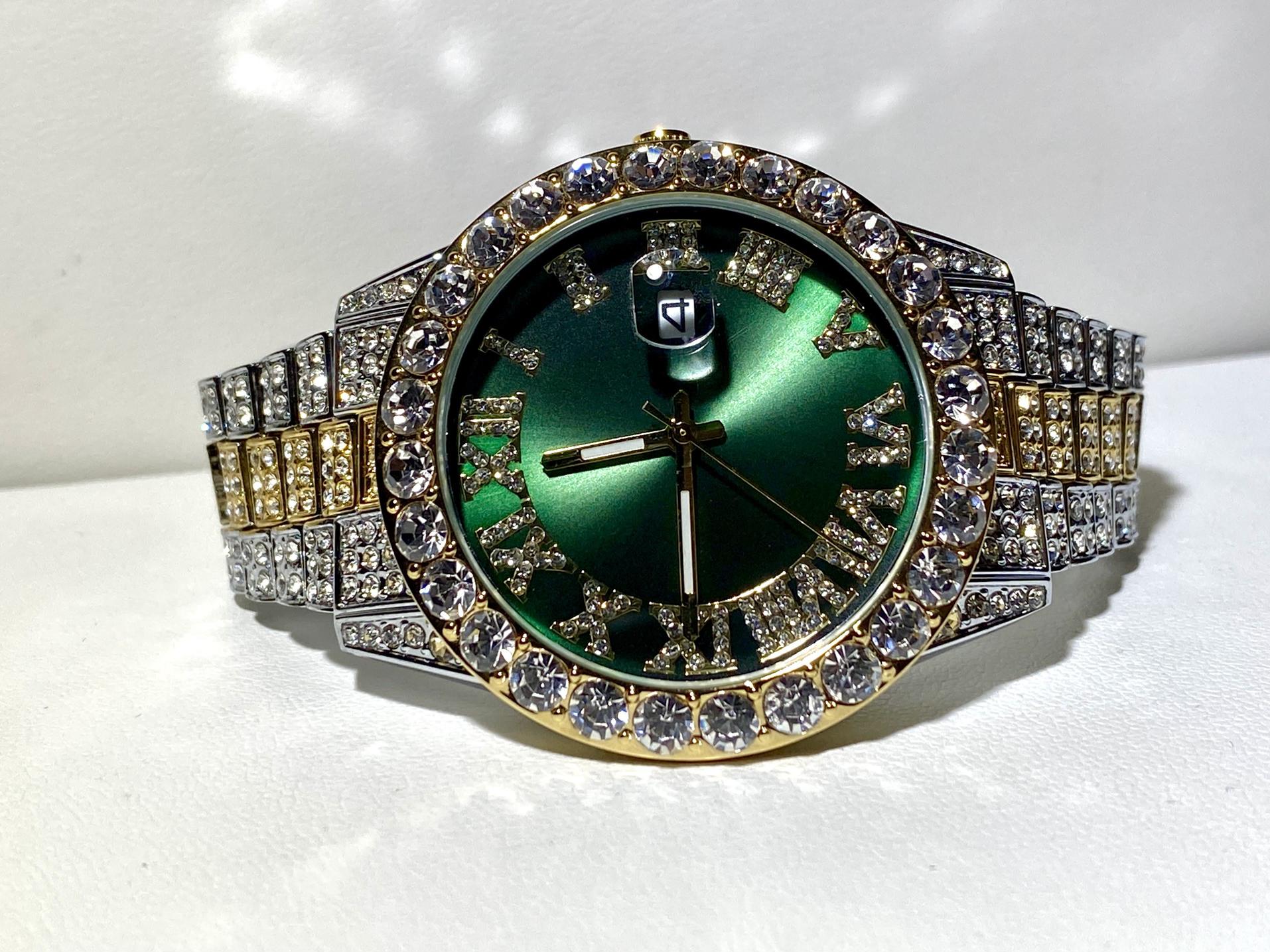 Two-tone iced-out watch with green Roman numeral dial and crystal bezel – luxury statement timepiece