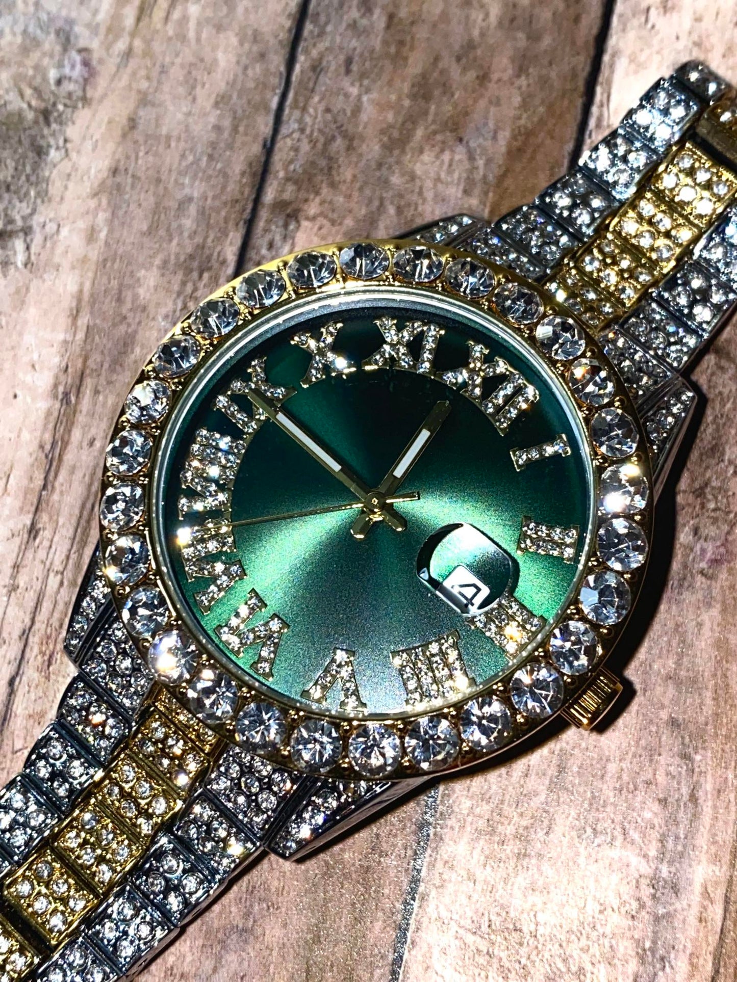 Two-tone iced-out watch with green Roman numeral dial and crystal bezel – luxury statement timepiece