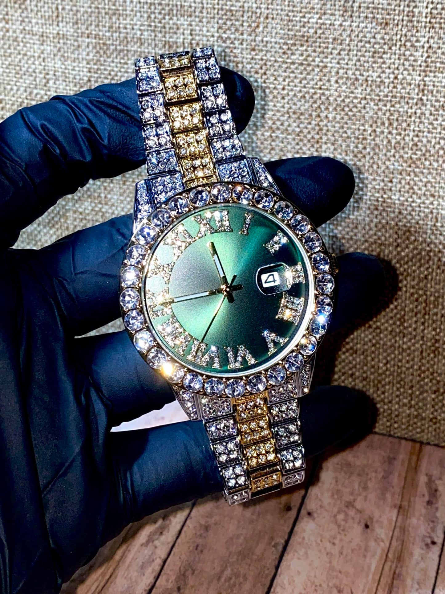 Two-tone iced-out watch with green Roman numeral dial and crystal bezel – luxury statement timepiece
